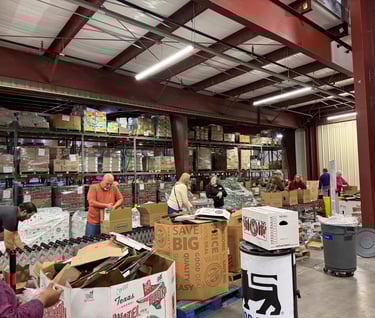 People working on a line at a food distribution center