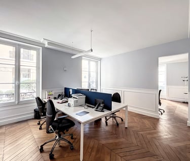 a desk with a computer and a laptop