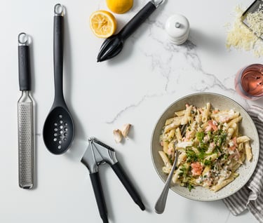Food product photography - a bowl of pasta with a glass and utensils