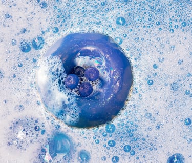 a blue doughnut in a bathtub with bubbles