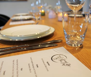 a table with a menu card and wine glasses