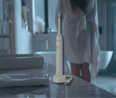 a woman in a robe is standing in front of a sink