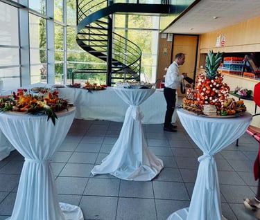 a table with a table with a lot of food and a spiral staircase