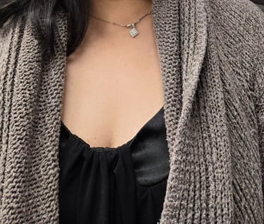 A woman smiling with medium length black hair