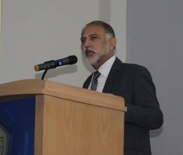 a man in a suit and tie is standing at a podium