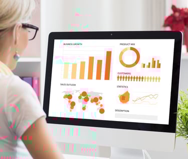 Woman in front of computer with data visualization