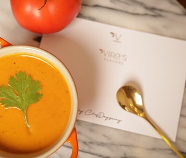 a cup of soup with a tomato soup in a bowl