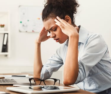 Woman holding head and looking frustrated