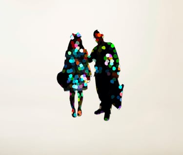 a couple of people standing in front of a white wall