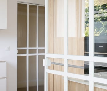 a kitchen with a wooden floor and a white cabinet