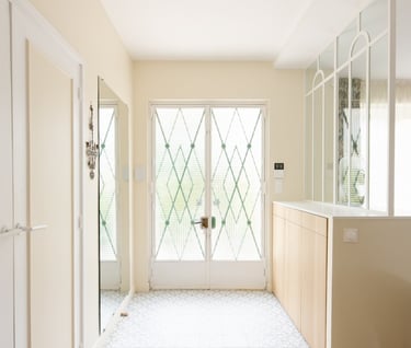 a hallway with a large window and a door