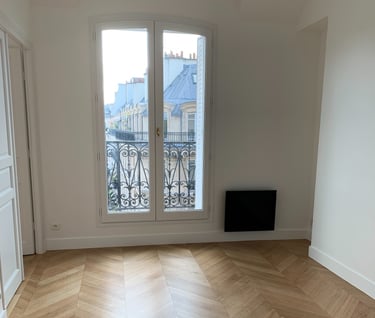 a room with a large window and a television