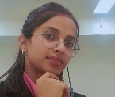 a woman in glasses and a pink shirt