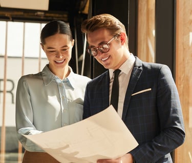 a man and woman in business attire standing in a room