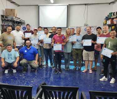 a group of people standing around a table with certificates. , Entrega de Certificados en ICL