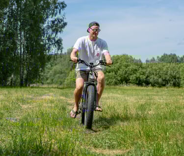 a man riding an electric bicycle in a field