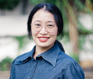 a woman in a denim shirt and glasses