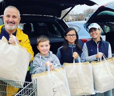 a group of people standing in front of a car