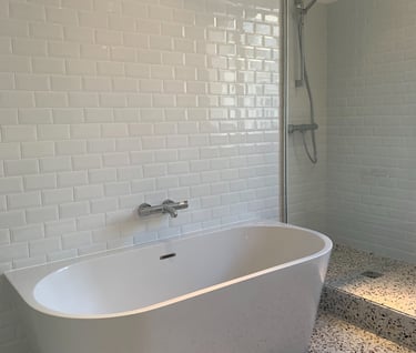 a bathtub with a shower and a shower