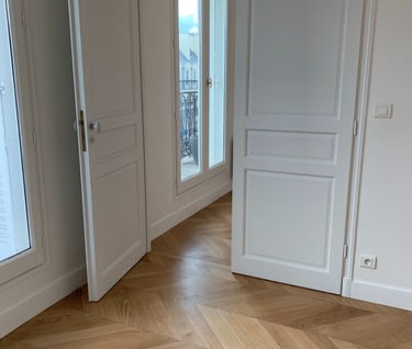 a room with a door and a door way to a balcony