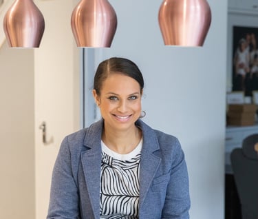 branding image of a woman sitting at a table with a cup of coffee