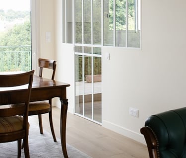 a dining room with a table and chairs