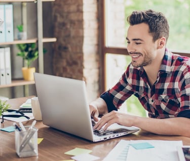 Smiling man in front of computer