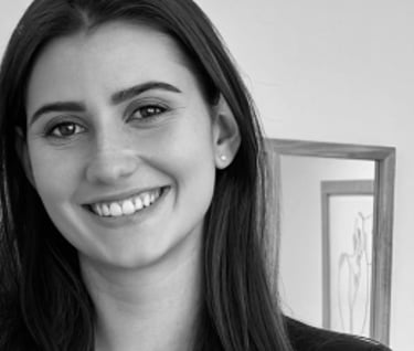 a woman in a suit and tie smiling for the camera