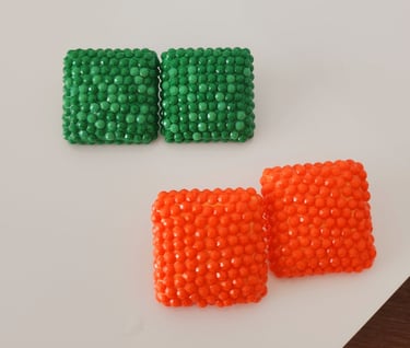 two pieces of beads on a white surface