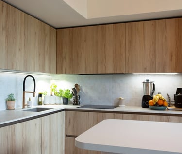 a kitchen with a large light fixture and a wooden floor