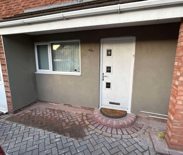 Close-up of textured render applied to an exterior wall in a home renovation