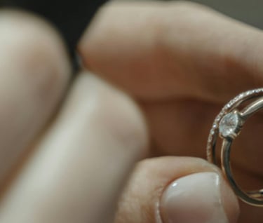a professional valuer inspecting a diamond ring under a magnifying loupe