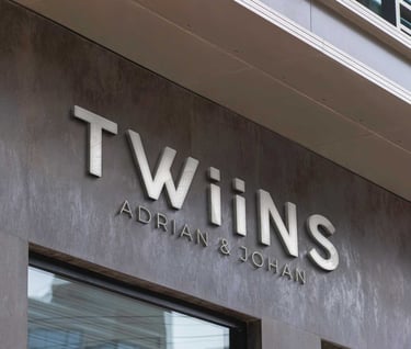 a building with a sign that says twins and luxury logo