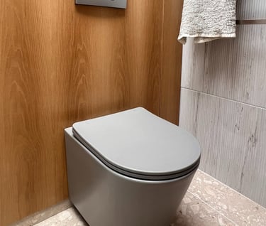 grey toilet and oak paneling