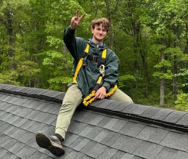 a man sitting on a roof top of a roof