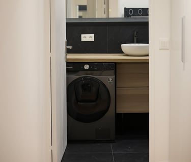 a washer in a bathroom with a sink and a washer