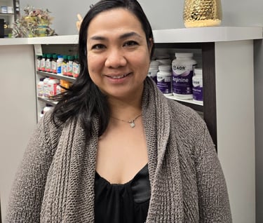 A woman smiling with medium length black hair