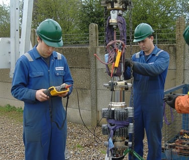 a group of men in blue workwears and safety gear