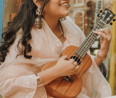 a man and woman playing guitar together