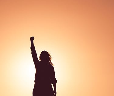a person standing on a hill watching sunrise