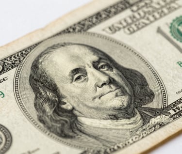 A macro photography shot focusing on the intricate textured details of vintage currency paper. The lighting highlights the fine engravings and fiber patterns against a backdrop of Soft Alabaster White, emphasizing visual simplicity and scholarly research.