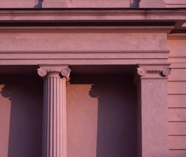 An elegant, minimalist architectural detail of a classical International / Western bank building, bathed in deep plum and dusty rose sunset shadows.