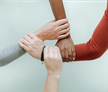a group of people holding hands together suggesting harmony and inclusion