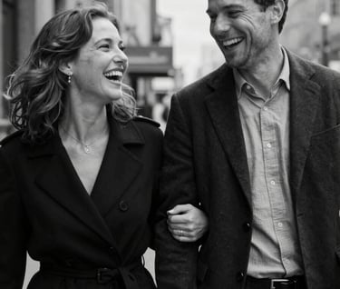 A candid, high-end black and white photograph of a couple laughing during a stroll in a clean, urban North American setting. Soft grain, cinematic lighting, professional photography.