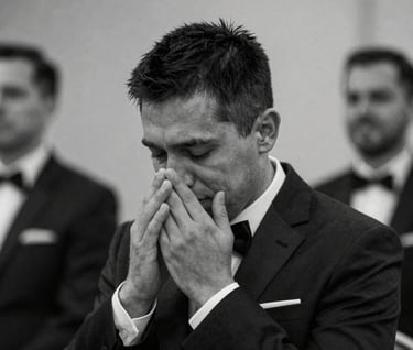 Candid black and white shot of a groom's emotional reaction, deep charcoal tones #3D3A38, professional depth of field, focused on authentic storytelling and raw emotion.