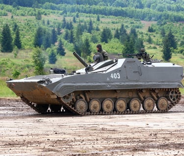 a tank - BMP-1 tank sitting on a dirt road