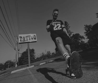 Jaris Ink next to tattoo sign
