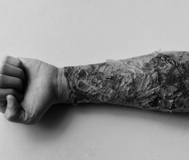 a scabbing tattoo man's arm with a tattoo on it