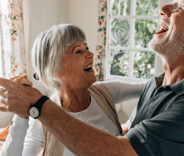 Older couple smiling and dancing together