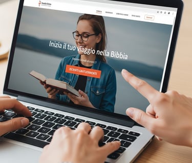 a person holding a book and pointing at a laptop